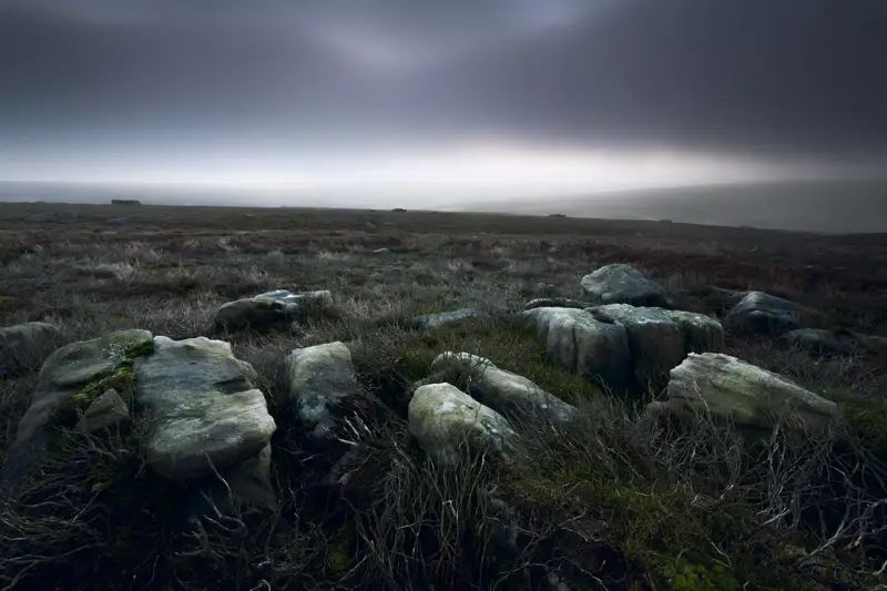 Barren moorland landscape. a herd of sheep standing on top of a hill. grass sky outdoor landscape cloud field plant hill nature