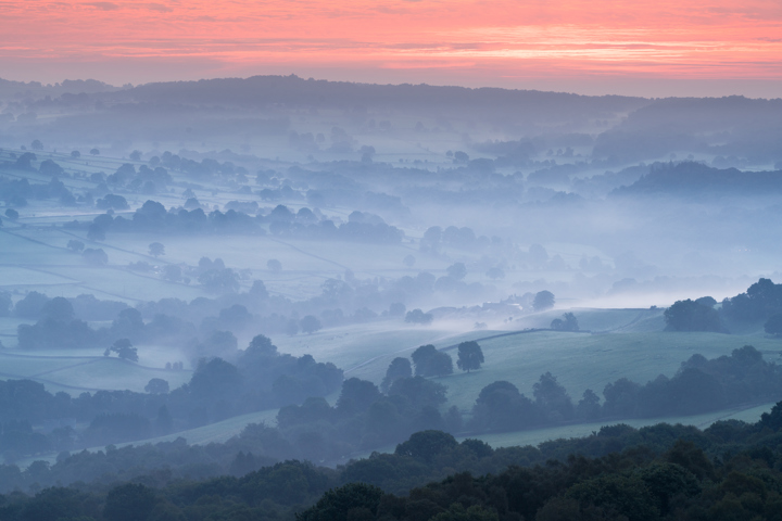 a foggy valley with trees. landscape sunrise outdoor mountain cloud fog sky mist haze morning sunset nature dawn
