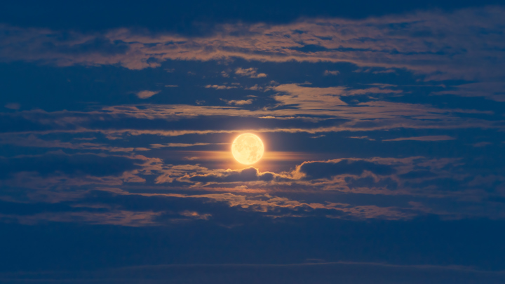 a sunset with clouds. cloud sky outdoor astronomical object nature moon heat celestial event calm sun sunset