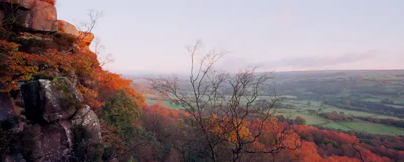 a view of a valley with trees and hills in the background. landscape outdoor sky autumn tree nature fall mountain plant natural landscape wilderness national park cliff