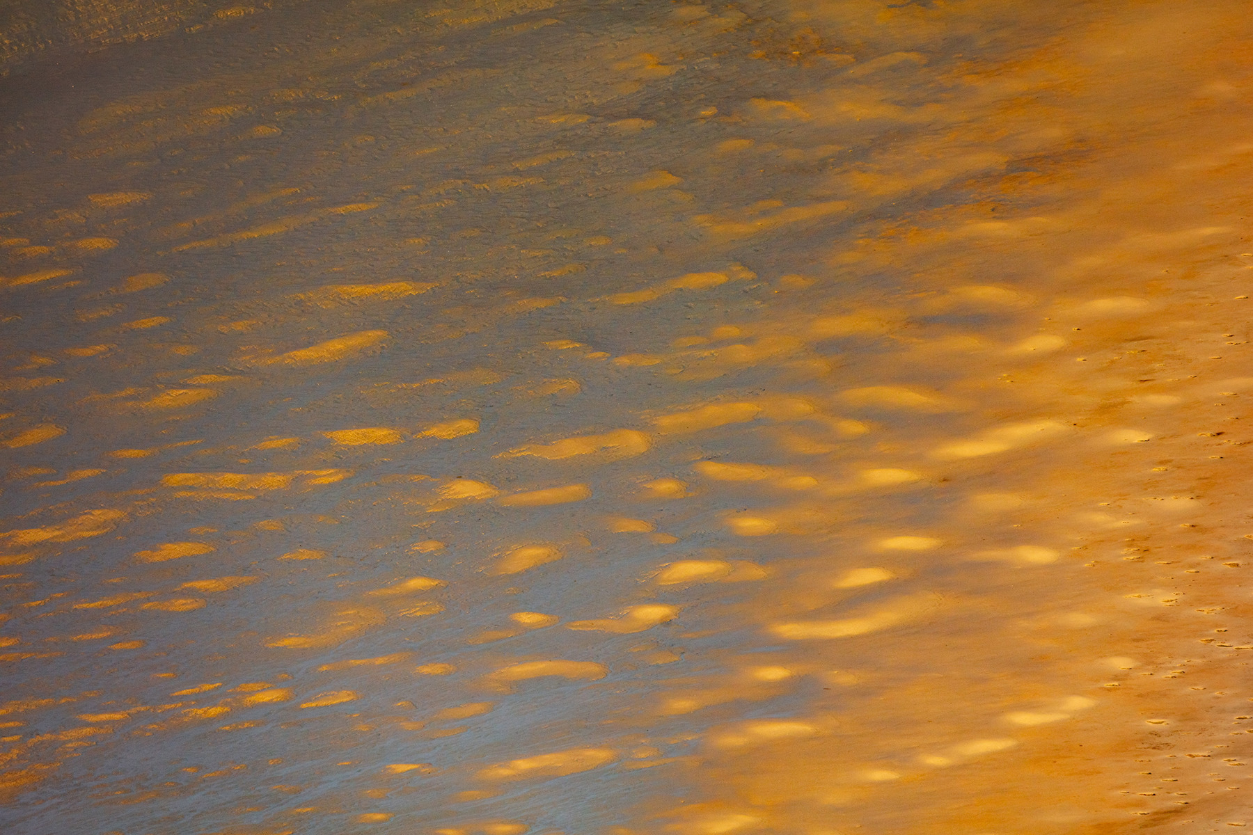a body of water with orange and yellow clouds. water amber gold orange abstract yellow