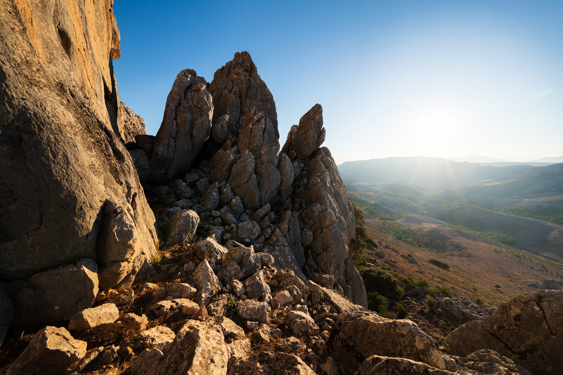 a rocky mountain with a valley below. outdoor nature mountain sky landscape bedrock outcrop geology building material formation badlands terrain batholith escarpment erosion rock stone wadi intrusion national park wilderness massif