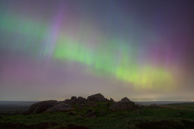 Aurora Borealis above moorland outcrop