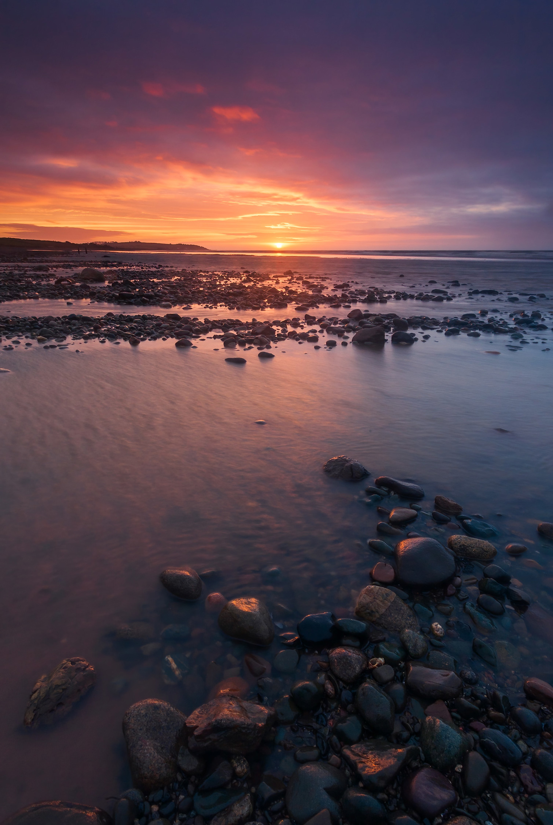 a rocky beach with a sunset. water outdoor cloud sky nature sunrise landscape horizon beach calm body of water ocean coastal and oceanic landforms dusk sea sunset seascape rock ground shore