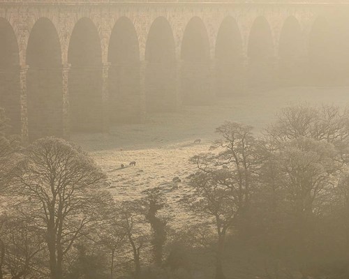 Crimple Valley Viaduct: A Marvel of Engineering and Beauty: Distant view of the Crimple Viaduct on a cold frosty morning a close up of a bridge
